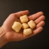 pawverest-product-scale-hand-1200 An open hand holding five puffed Pawverest Crunch cheese treats of different sizes, showing their real size against the palm.